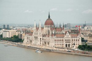 Aerial view of the iconic Hungarian Parliament Building along the Danube River in Budapest, Hungary.